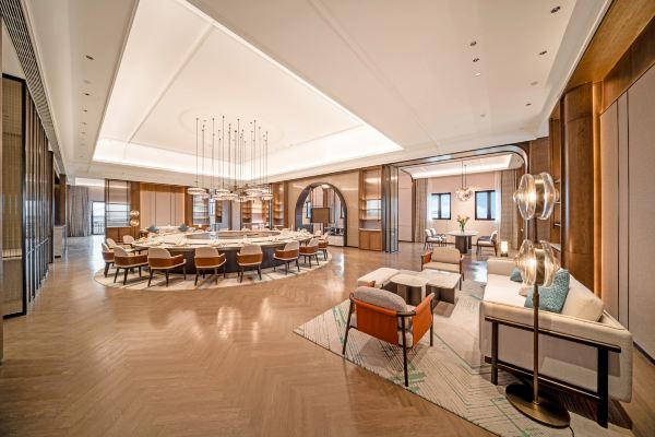 An elegant hotel restaurant with warm lighting, neatly set tables, and a refined, contemporary dining atmosphere.