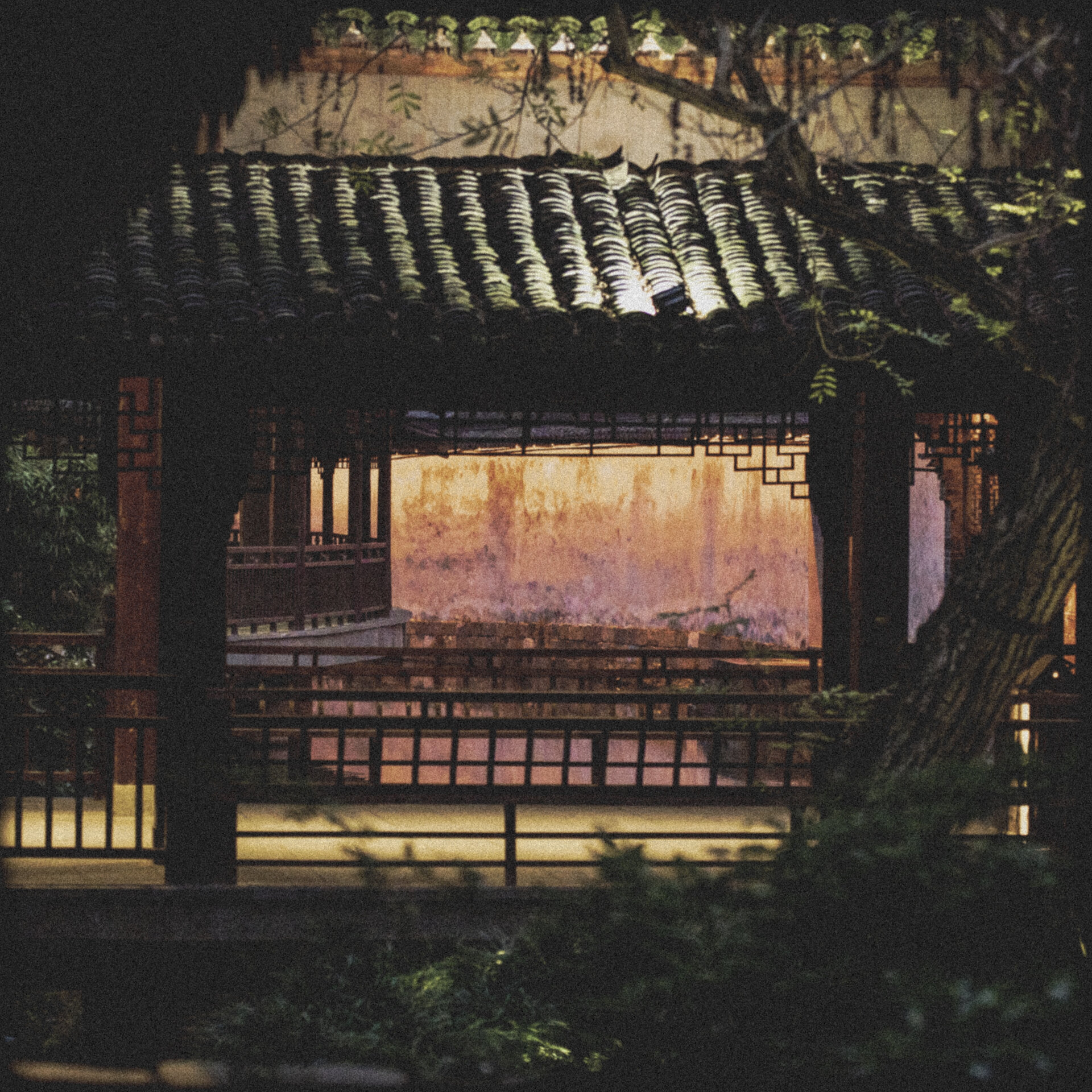 Illuminated ancient wooden pavilion in dark night scenery.