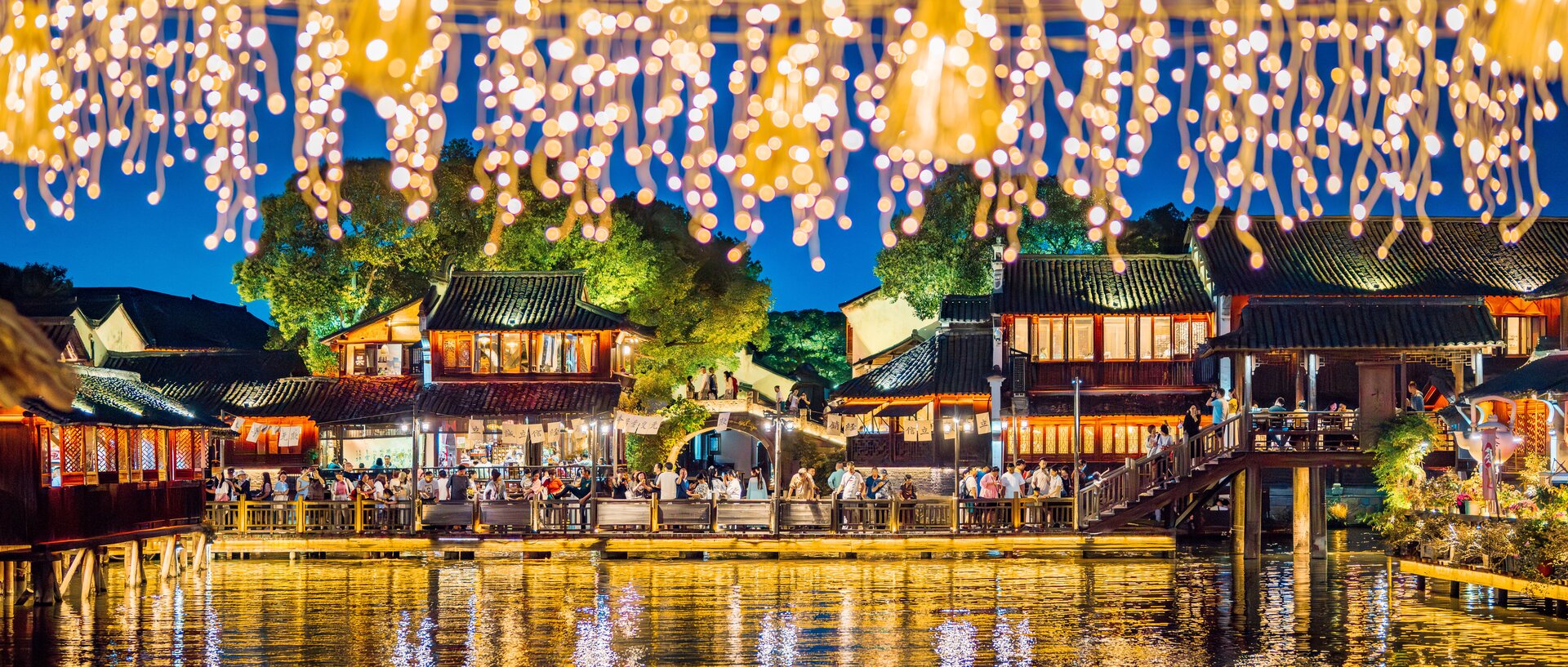 Twinkling light decorations over wuzhen water town at night.