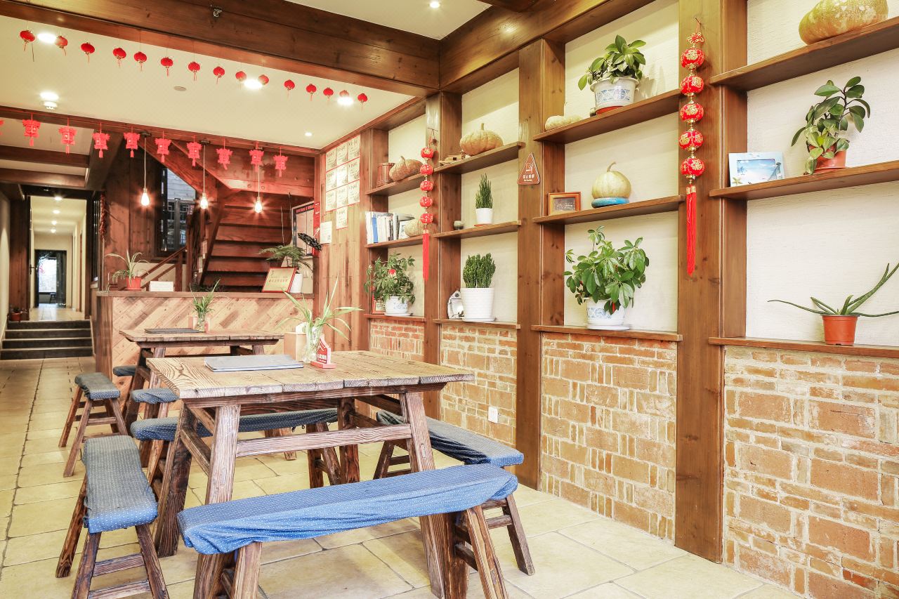 Warm guesthouse dining area with wooden interiors and local decor.