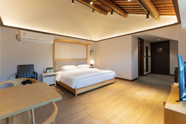Interior of a superior double room with spacious layout and simple furnishings.