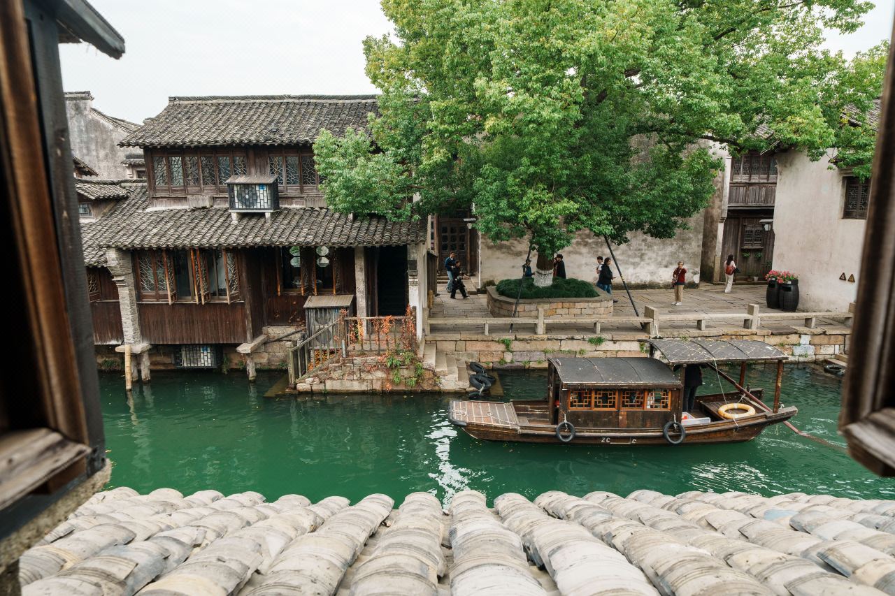 Traditional courtyard with pond and classic Jiangnan architectural details.