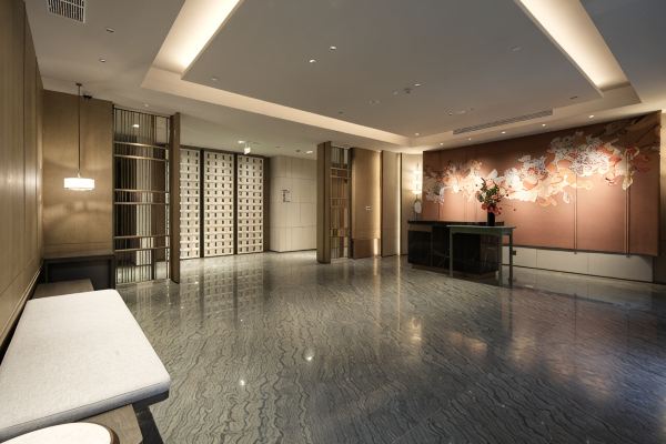 Secondary lobby view with warm lighting and open layout.