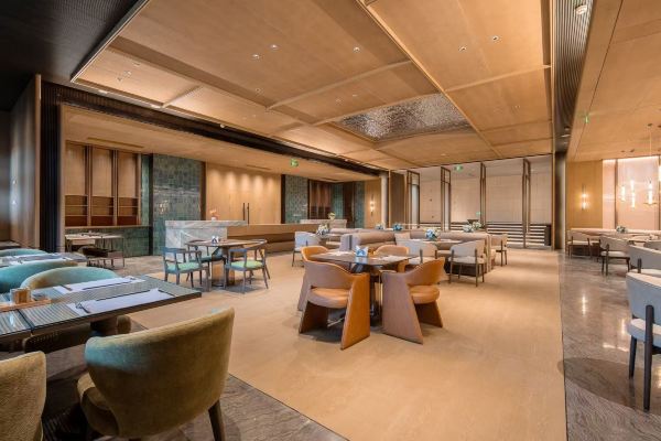 Restaurant interior with dining tables and warm lighting.