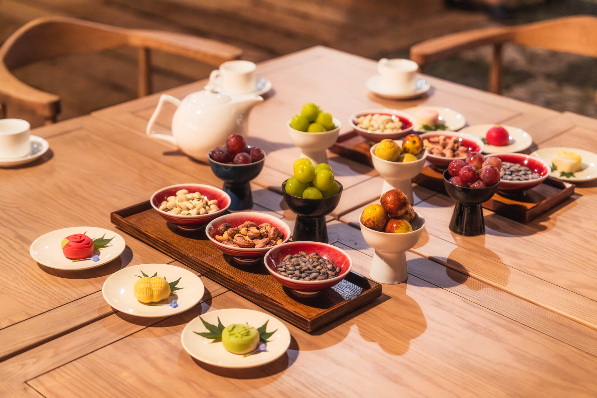 Delicate tea snacks are presented on elegant plates.