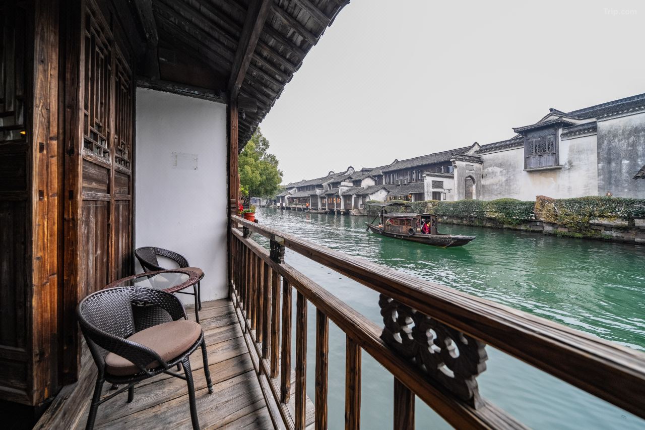 Canal-facing balcony with traditional railings and water town scenery.