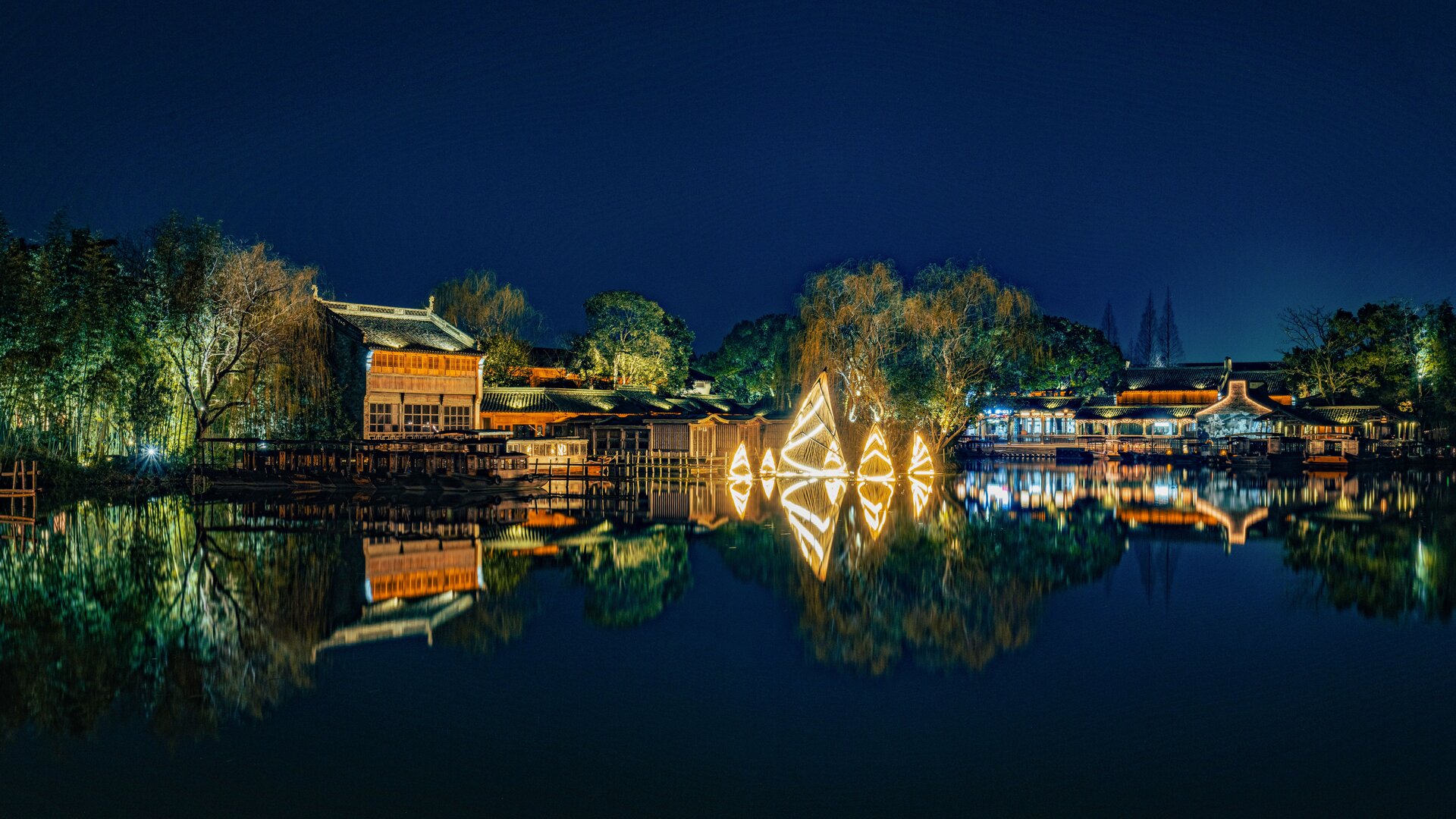 Night reflection of lit ancient architecture on yuanbao lake.