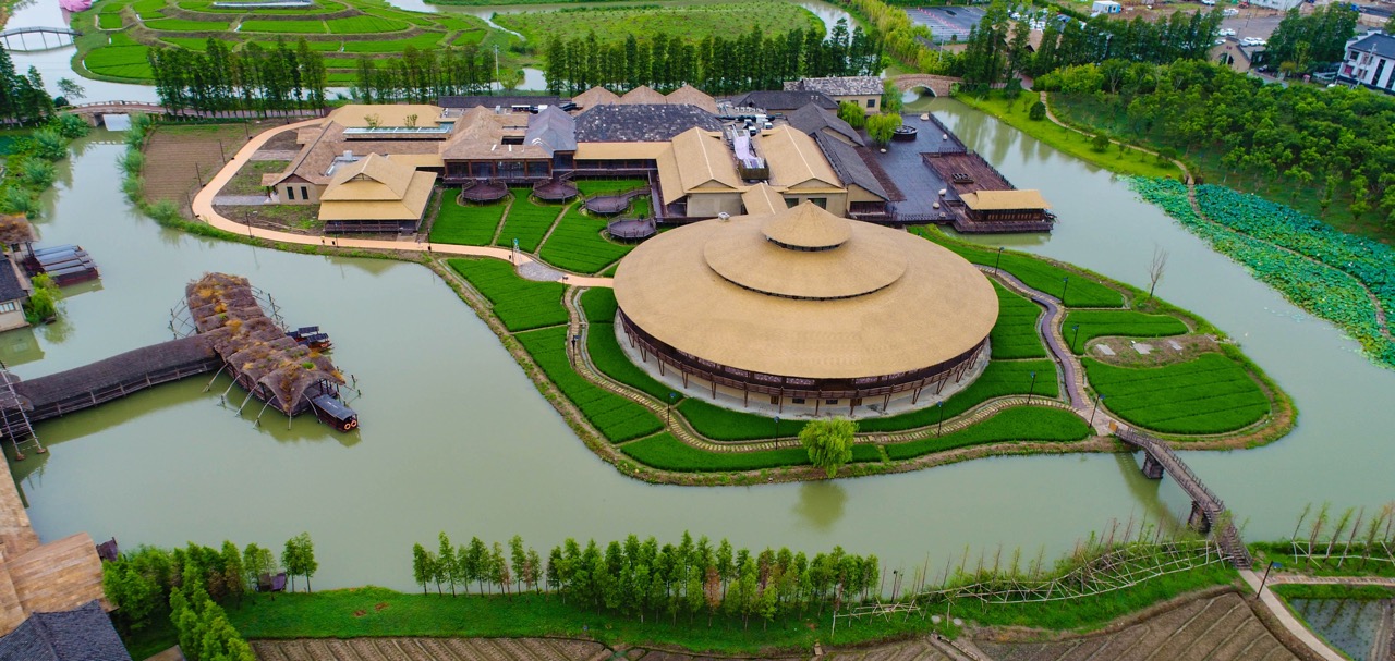 Overhead shot of Wucun rural resort with round building and canals.
