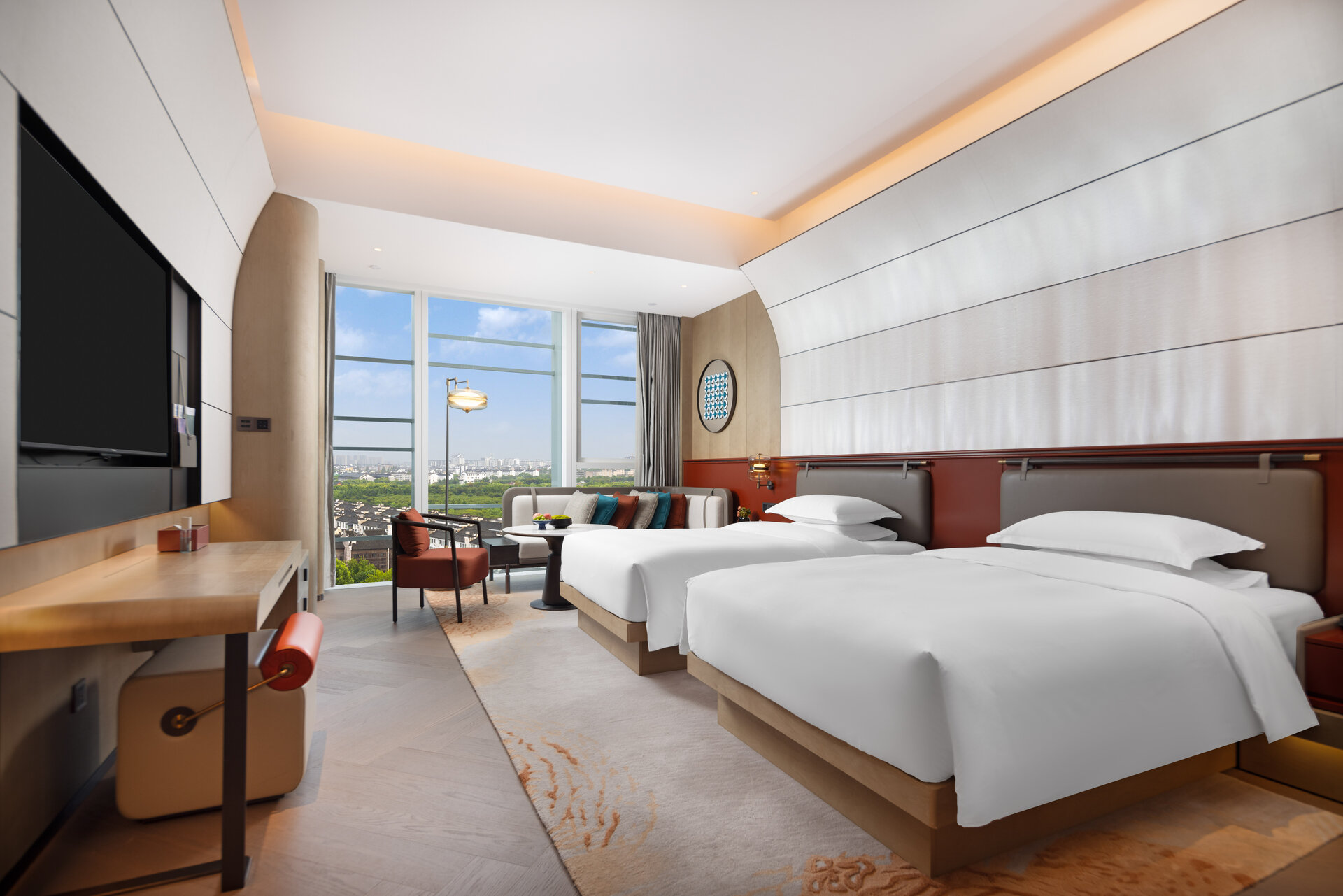 Interior of a deluxe twin room with two beds and contemporary decor.
