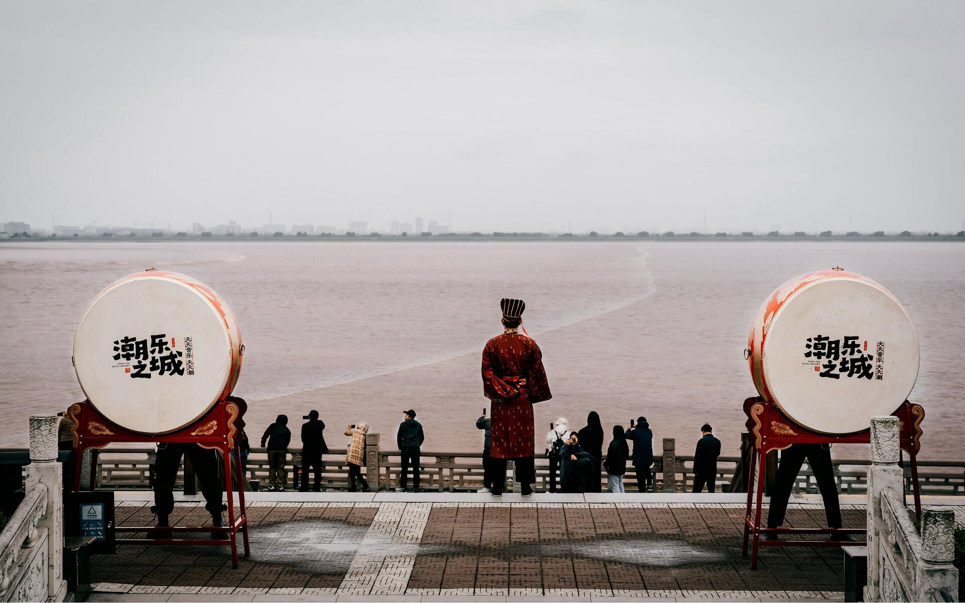 Performers beat drums to welcome the incoming tidal wave, a traditional ritual before the Qiantang River bore.