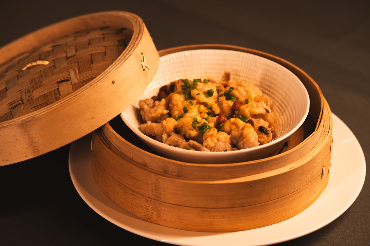Marinated pork ribs steamed inside bamboo basket.