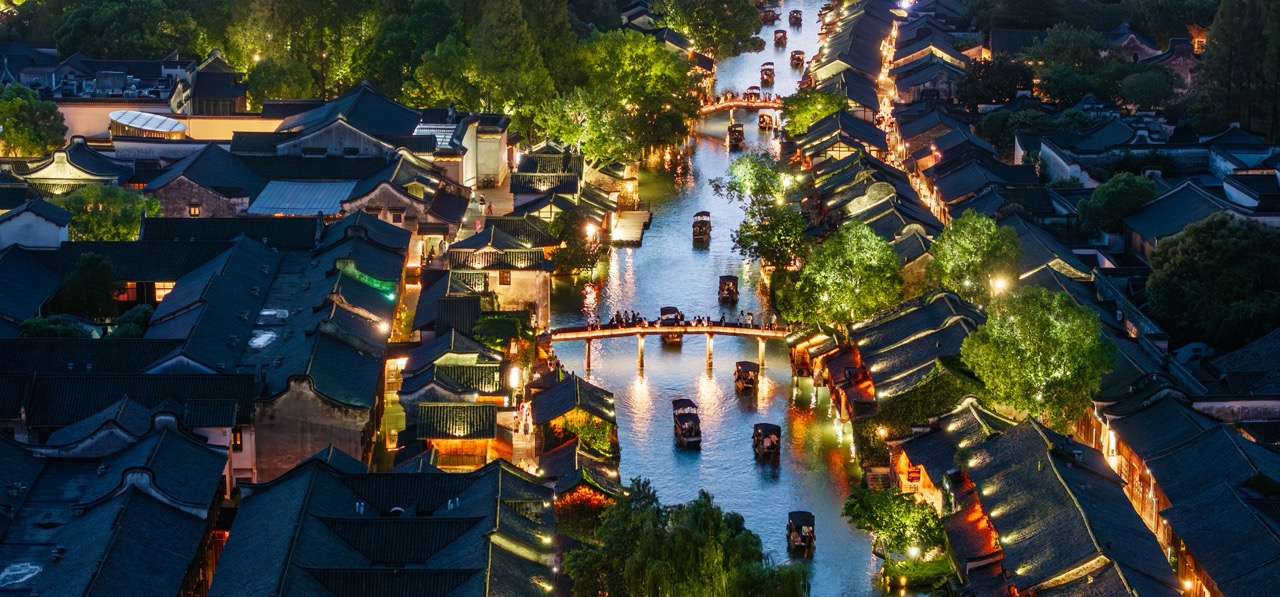 Busy wuzhen xizha waterway full of glowing boats at night.