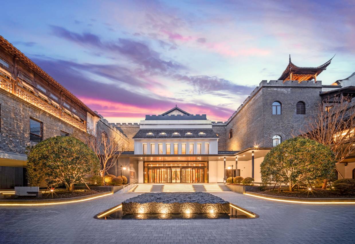 Exterior of Main Vocal Hotel at dusk.