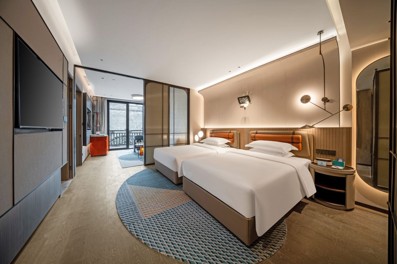 Interior of a hip-hop themed family room with twin beds and a balcony.