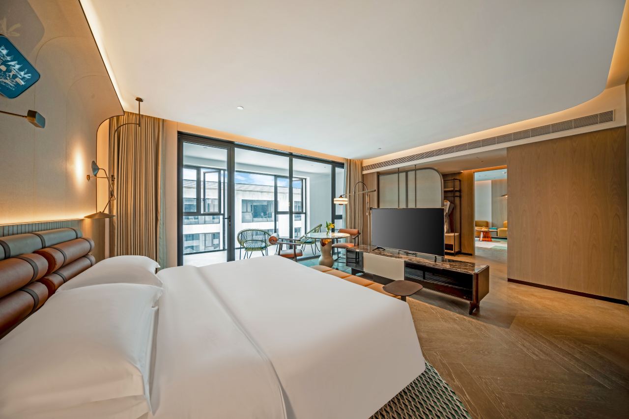 Interior of a jazz suite with a spacious layout, modern decor, and a balcony.