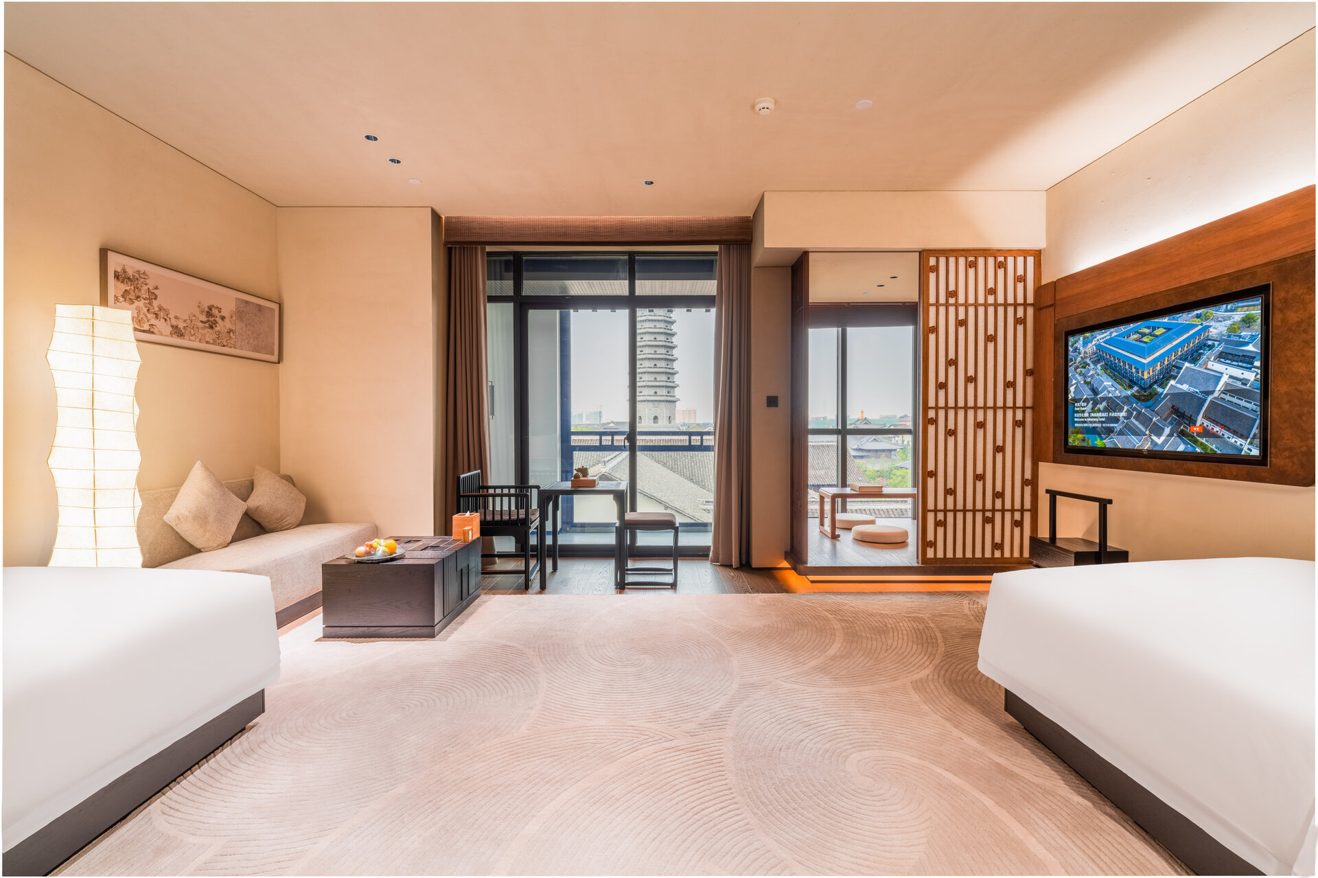 Interior of a deluxe courtyard twin room with traditional design elements and courtyard access.