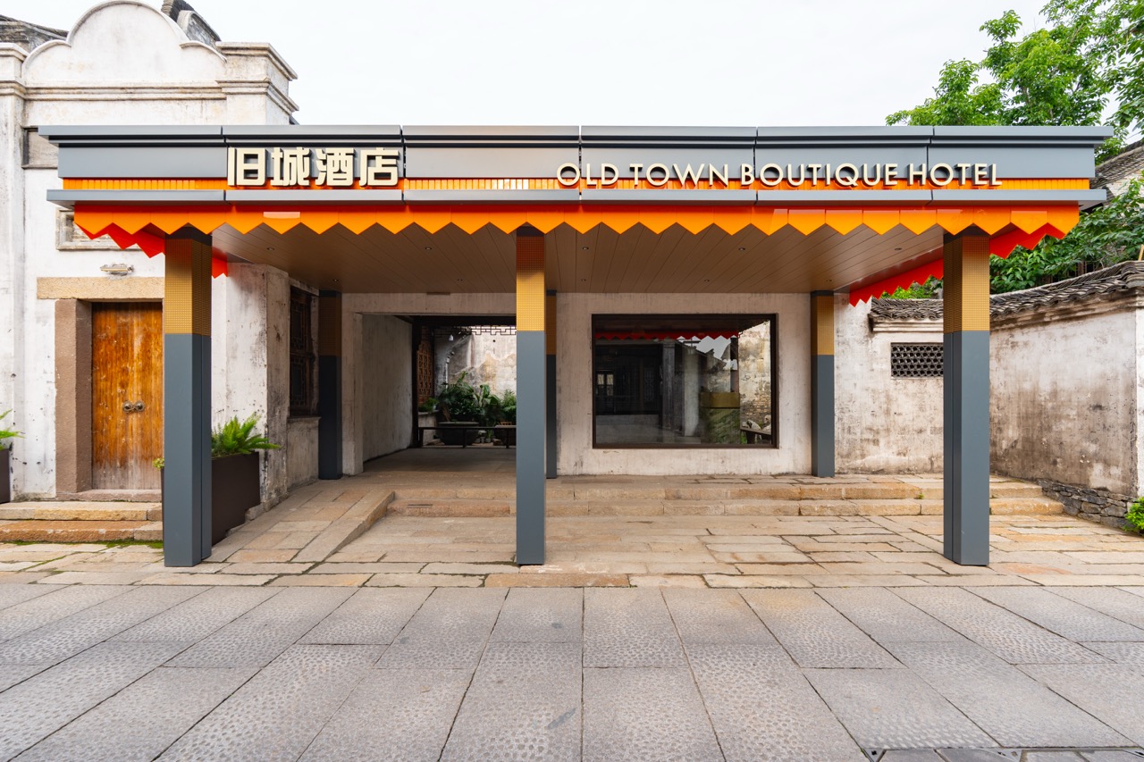 Exterior of Old Town Boutique Hotel located within Yanguan ancient town near historic city walls.