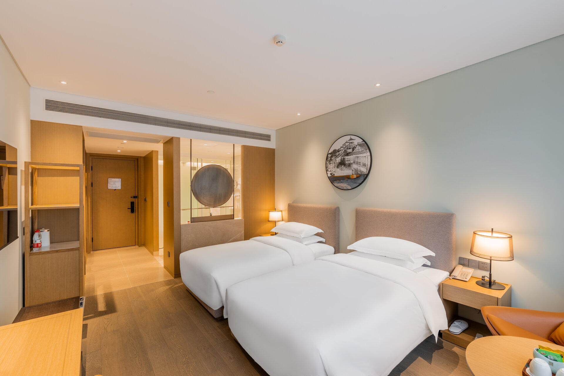 Interior of a deluxe twin room with two beds and modern decor.
