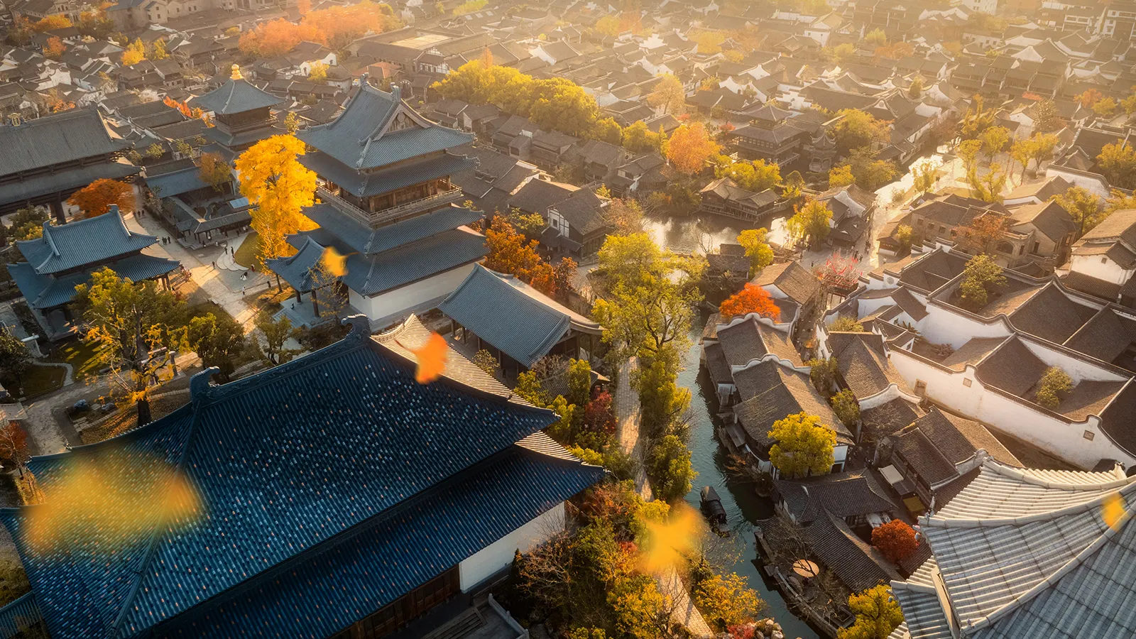 Golden fall foliage framing ancient towers and water canals in Puyuan.
