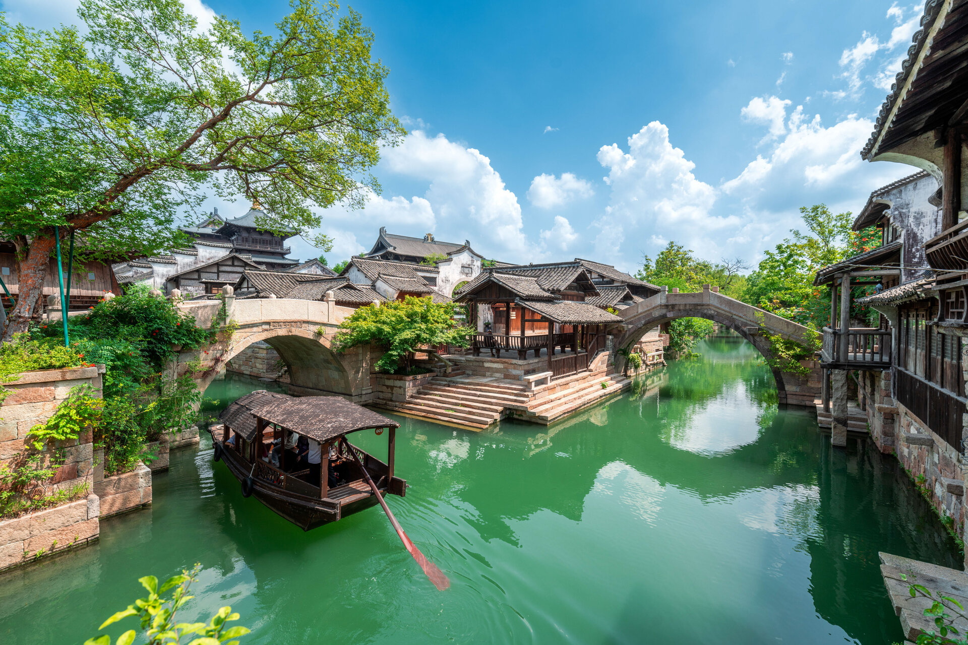 Traditional water town canal with stone bridges and wooden boat