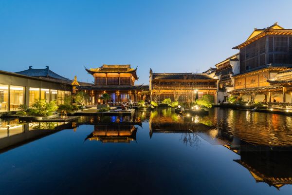 Scenic courtyard with traditional architecture and canal reflections.