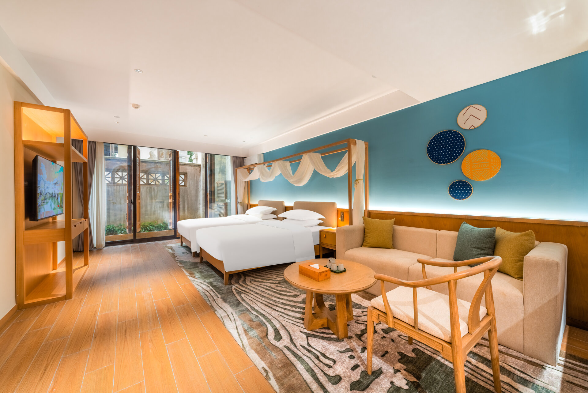 Interior of a deluxe courtyard twin room with traditional wooden furnishings and courtyard view.