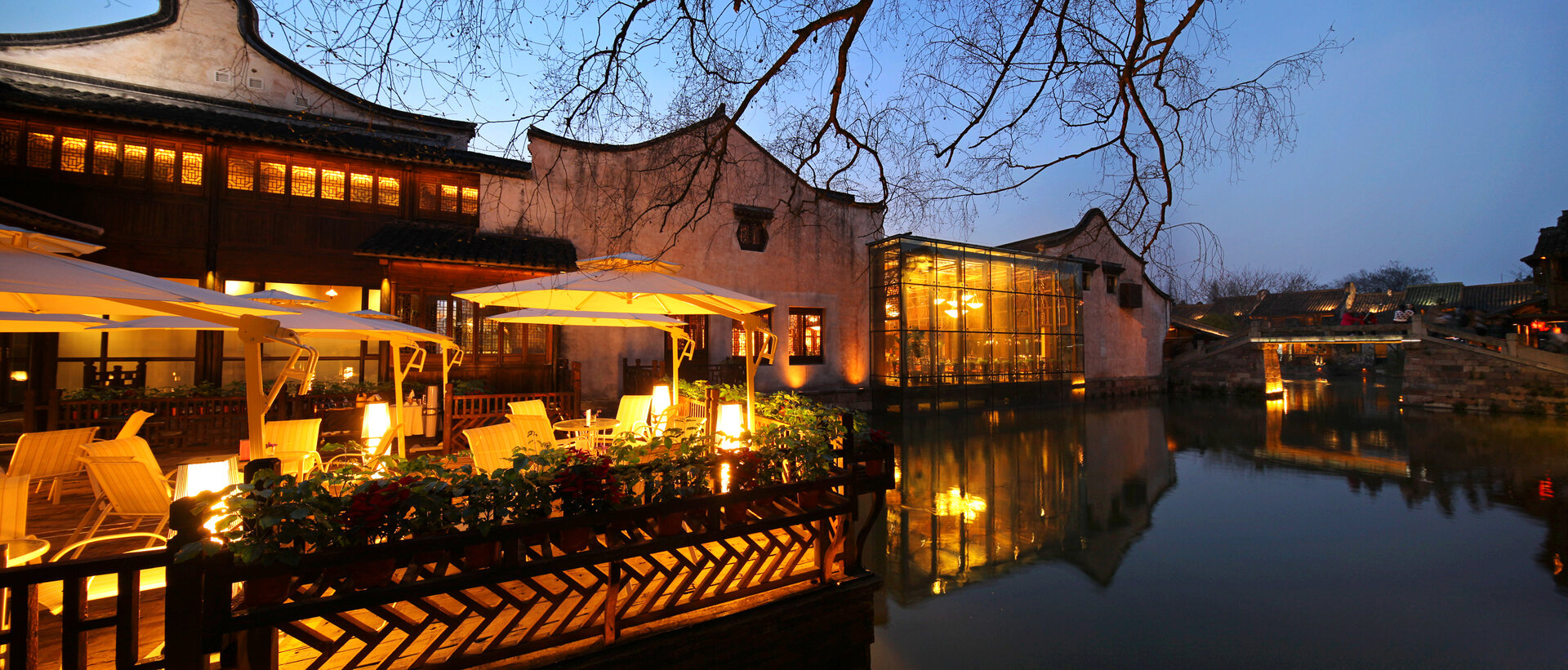 Exterior of Waterside Resort within Wuzhen scenic area featuring lighting atmosphere.