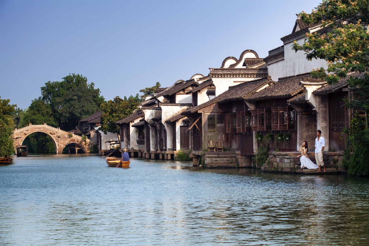Wuzhen ancient canal scenery with stone bridge and a couple.