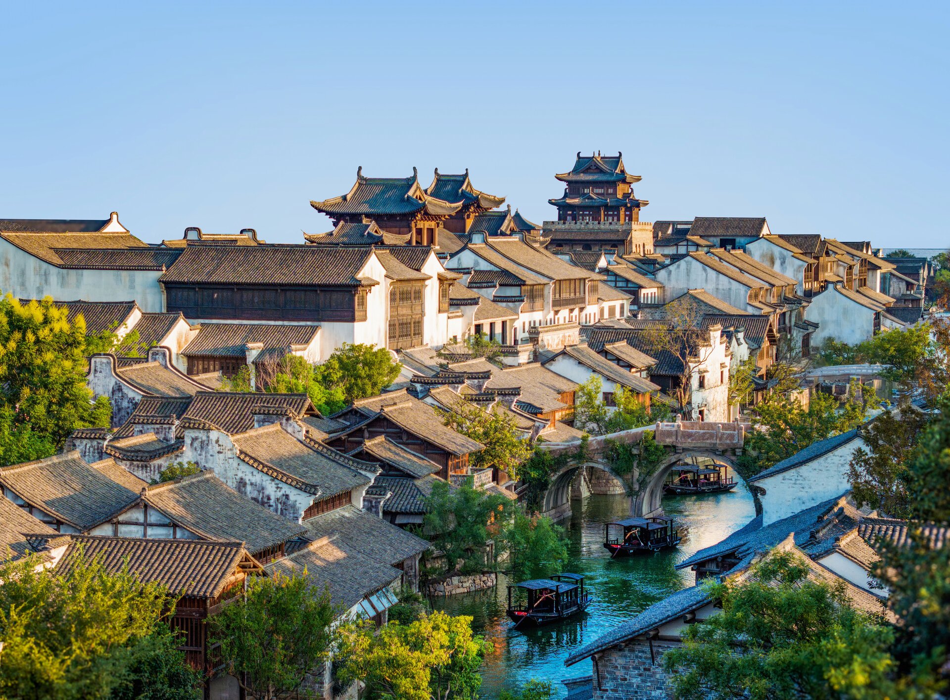 Panoramic view of the Yanguan scenic area, with ancient buildings of varying heights scattered along the river.