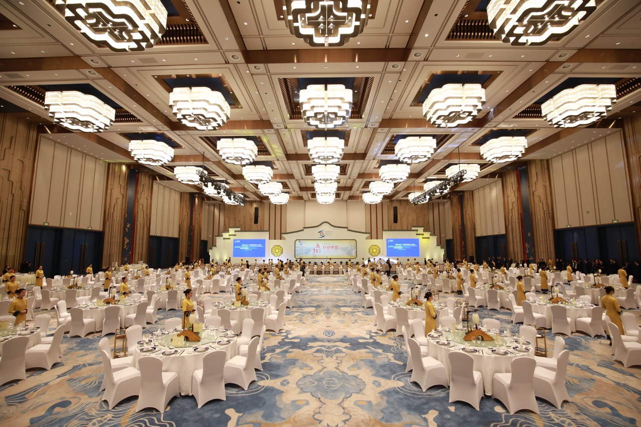 Spacious luxury ballroom with traditional Chinese chandeliers, fully set for large-scale conference gala dinner.